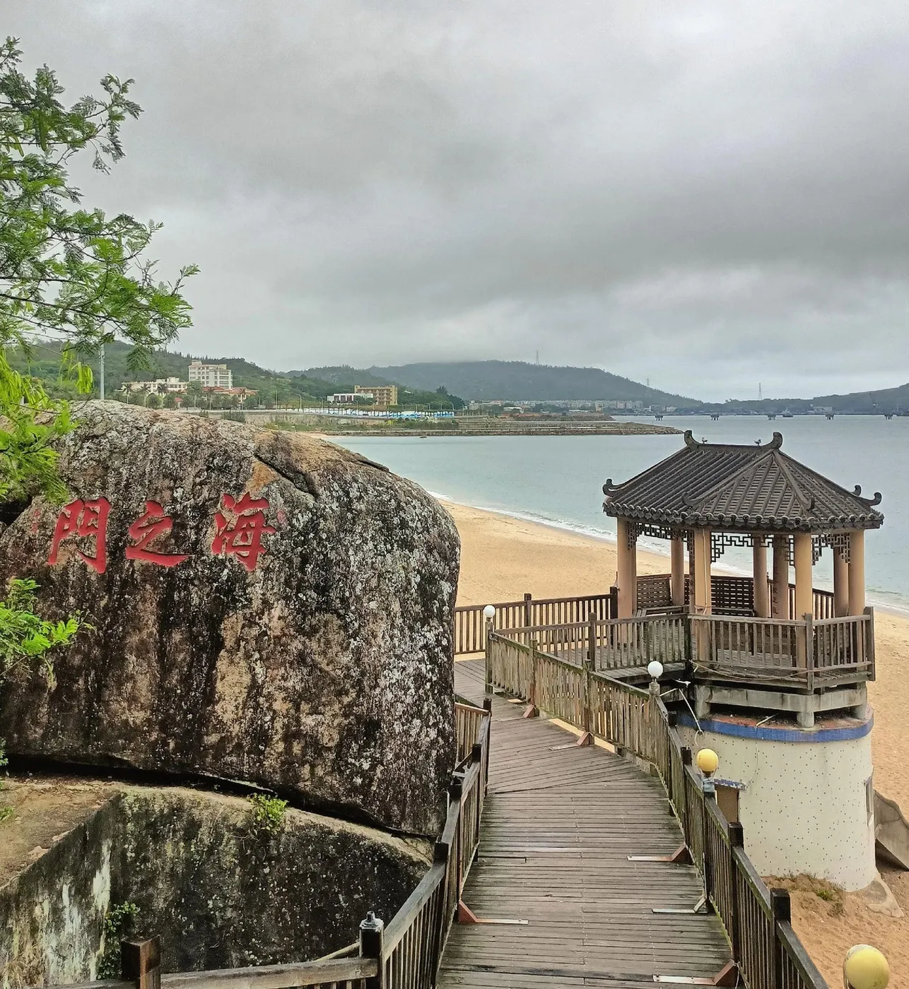 刻红色「门之海」三字的巨岩,旁有木栈道、亭与沙滩